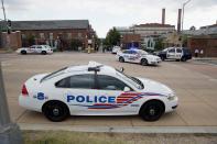 Police cars are parked outside the U.S. Navy Yard after a shooting in Washington September 16, 2013. (REUTERS/Joshua Roberts)