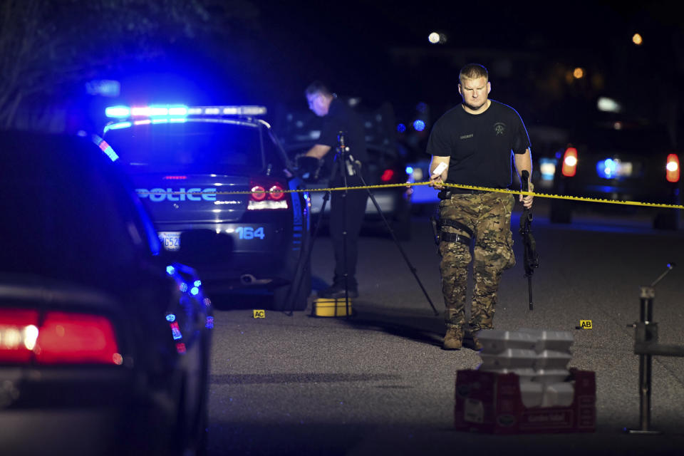 A sheriff's deputy exits the crime scene on Ashton Drive in the Vintage Place neighborhood where several members of law enforcement were shot, one fatally, Wednesday, Oct. 3, 2018, in Florence, S.C. (AP Photo/Sean Rayford)