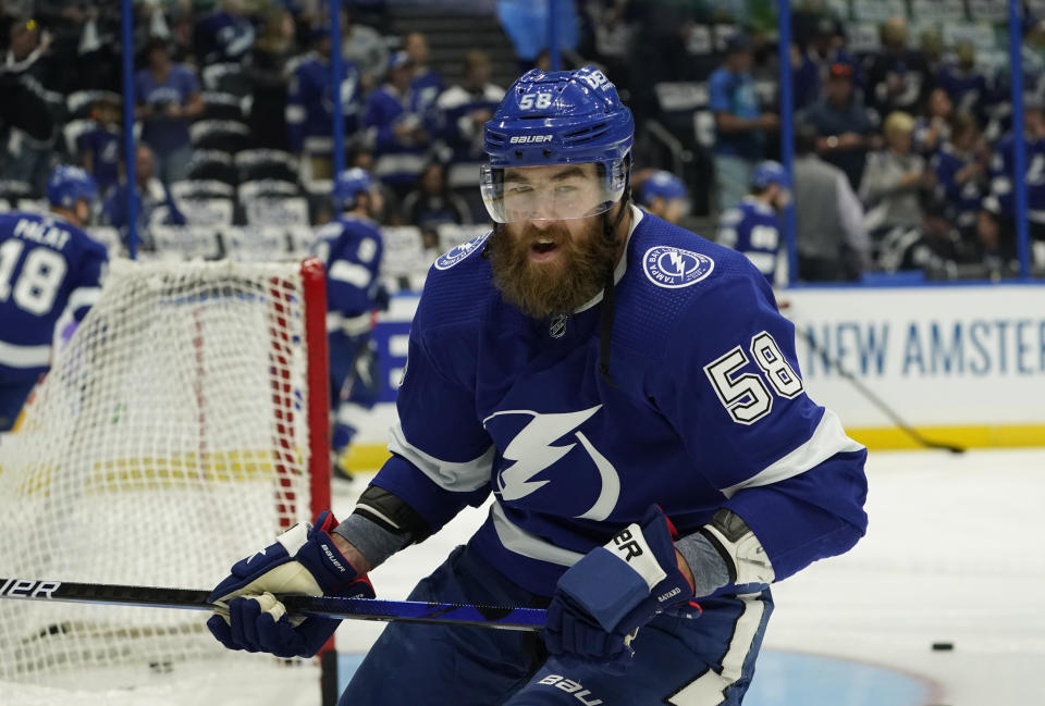 File-This June 13, 2021, file photo shows Tampa Bay Lightning defenseman David Savard (58) before Game 1 of an NHL hockey Stanley Cup semifinal playoff series against the New York Islanders in Tampa, Fla. Almost everyone on the Tampa Bay Lightning won the Stanley Cup. Trade deadline pickup Savard hasn't, so his teammates want to win it again for him. The New York Islanders, Vegas Golden Knights and Montreal Canadiens have a few players or coaches with Cup rings and plenty more hungry for their first championship in the NHL. At a time of year that puts a spotlight on older guys who have never lifted the Cup, all four teams left have at least one player with gray hairs in his beer worth rooting for to finally get that opportunity. (AP Photo/Chris O'Meara, File)