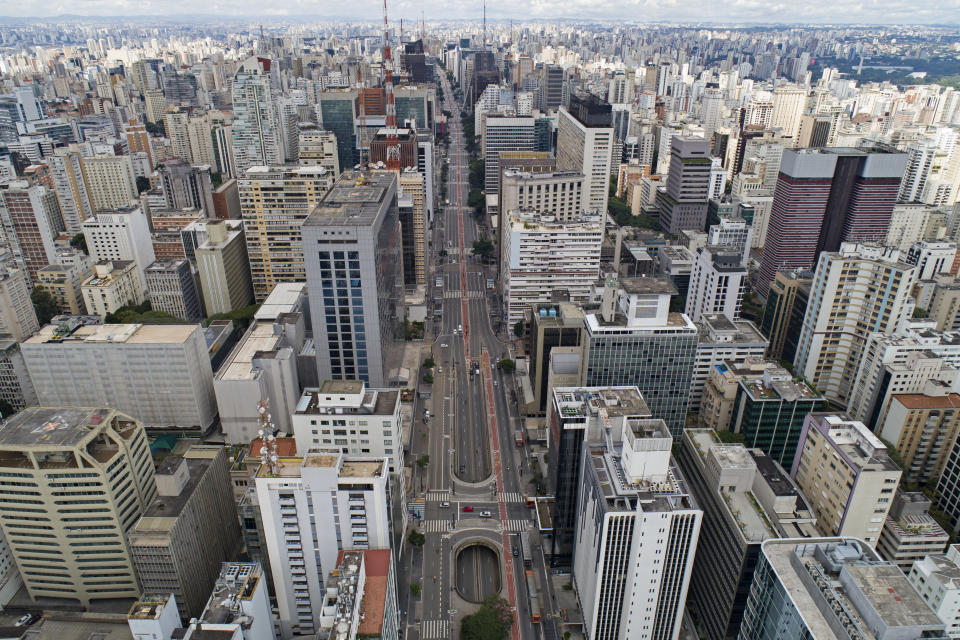 An aerial view of the almost empty Paulista Avenue, one of the city's most important financial center, on the first day of quarantine to help stop the spread of the new coronavirus in Sao Paulo, Brazil, Tuesday, March 24, 2020. (AP Photo/Andre Penner)