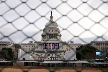 The U.S. Capitol building is seen behind a security fence in Washington, U.S., January 19, 2017. REUTERS/Shannon Stapleton