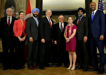 U.S. Homeland Security Secretary John Kelly (4th L) poses for a group photo with Transport Minister Marc Garneau (L), Science Minister Kirsty Duncan (2nd L), Innovation, Science and Economic Development Minister Navdeep Bains (3rd L), Public Safety Minister Ralph Goodale (4th R), Foreign Minister Chrystia Freeland (3rd R), Defence Minister Harjit Sajjan (2nd R), and Immigration Minister Ahmed Hussen (R) on Parliament Hill in Ottawa, Ontario, Canada, March 10, 2017. REUTERS/Chris Wattie