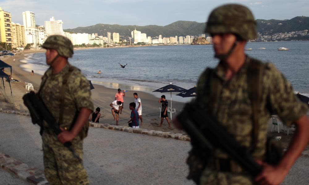 Soldiers stand guard in Acapulco. Critics say the new law will cement a failed strategy of using soliders to combat drug cartels.