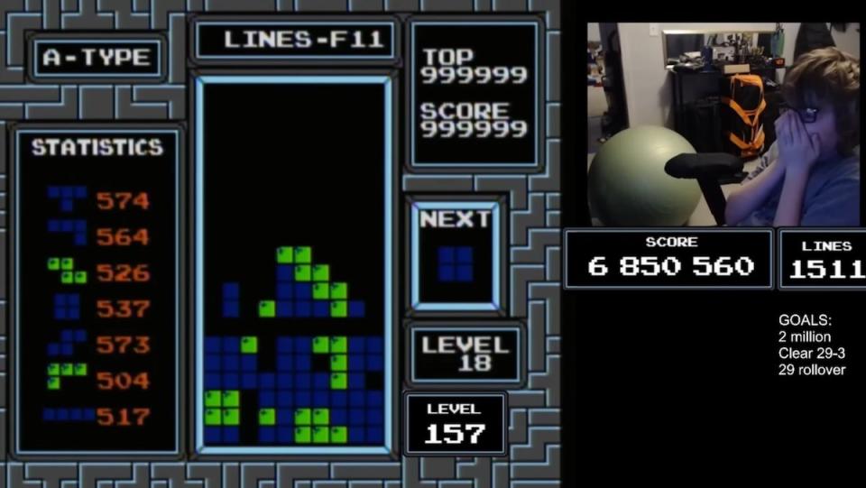 A Tetris screen frozen with an inlay of a kid holding his face in excitement