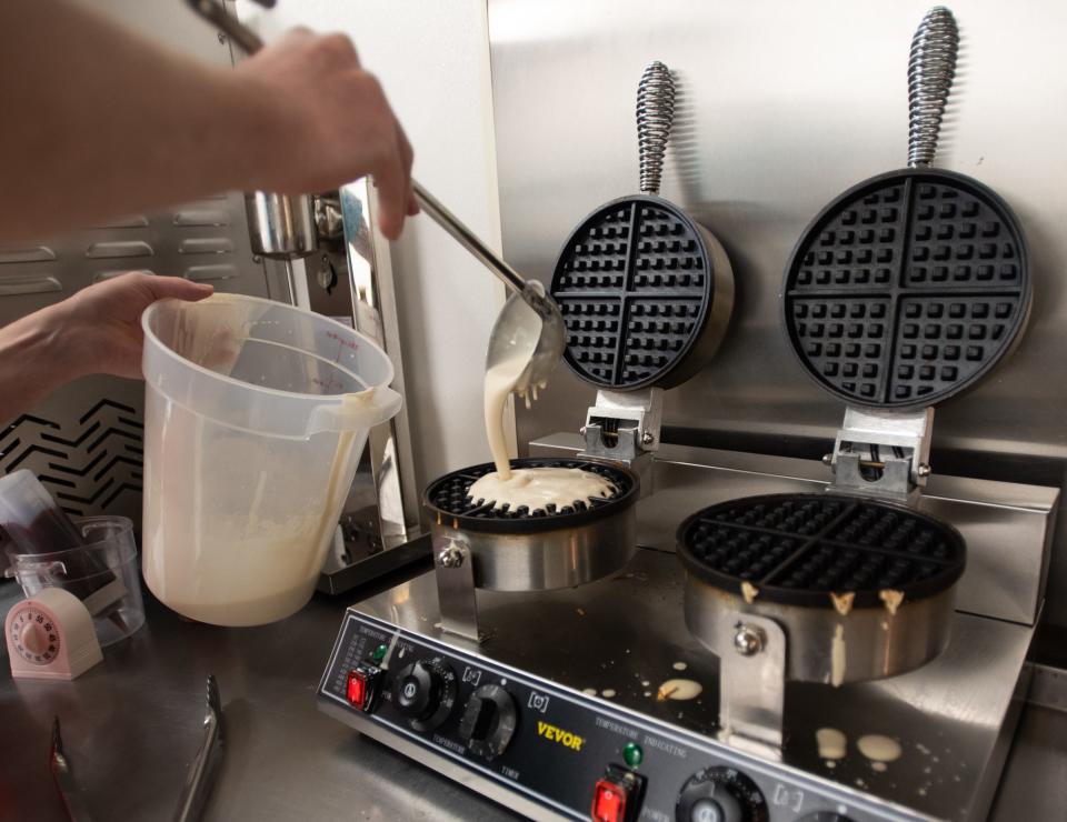 Elsa's Chicken & Waffles owner Nick Travelbee makes waffles Wednesday, May 3, 2023, at his new restaurant near Jolly and Waverly roads in Lansing.