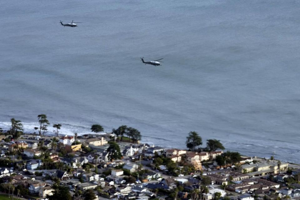 President Biden, aboard Marine One, right, flies over storm-ravaged areas in Northern California as he heads to Capitola.