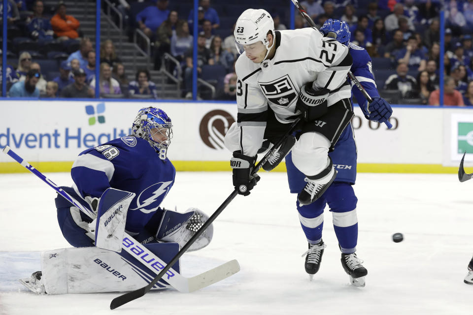 Los Angeles Kings right wing Dustin Brown (23) screens Tampa Bay Lightning goaltender Andrei Vasilevskiy (88) on a goal by left wing Kyle Clifford (not shown) during the first period of an NHL hockey game Tuesday, Jan. 14, 2020, in Tampa, Fla. (AP Photo/Chris O'Meara)