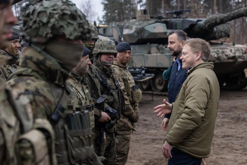 Grant Shapps and Polish defence minister Wladyslaw Kosiniak-Kamysz talk to British and Polish troops on Wednesday (AFP via Getty)