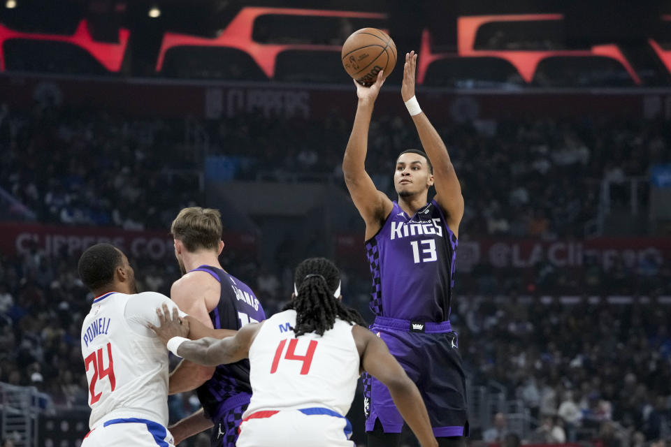 Sacramento Kings forward Keegan Murray (13) shoots against Los Angeles Clippers guard Terance Mann (14) during the first half of an NBA basketball game, Sunday, Feb. 25, 2024, in Los Angeles. (AP Photo/Ryan Sun)