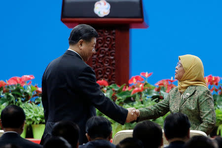 Chinese President Xi Jinping and Singapore President Halimah Yacob shake hands at the Conference on Dialogue of Asian Civilizations in Beijing, China May 15, 2019. REUTERS/Thomas Peter