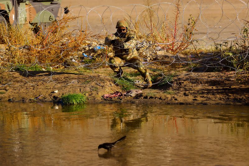 Members of the Texas National Guard stand guard on the banks of the Rio Bravo river with the purpose of reinforcing border security and inhibiting the crossing of migrants into the United States