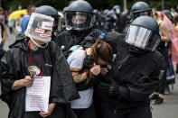 Police arrest a demonstrator at an unannounced demonstration at the Victory Column, in Berlin, Sunday Aug. 1, 2021, during a protest against coronavirus restrictions. Hundreds have turned out in Berlin to protest the German government’s anti-coronavirus measures despite a ban on the gatherings, leading to arrests and clashes with police. (Fabian Sommer/dpa via AP)