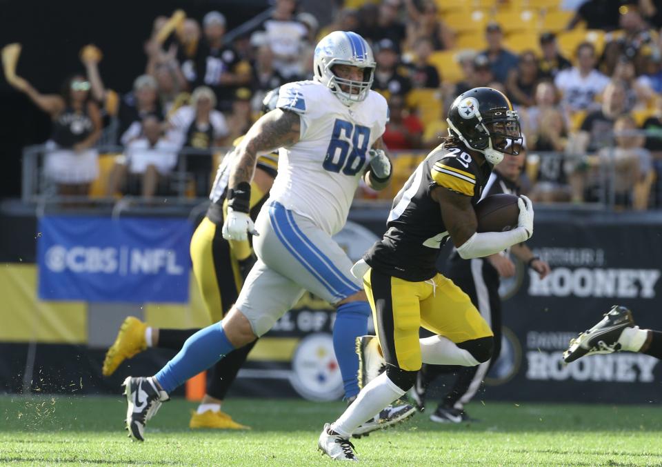 Pittsburgh Steelers cornerback Cameron Sutton returns an interception as Detroit Lions offensive tackle Taylor Decker chases him during the second quarter of a preseason game Aug. 28, 2022 in Pittsburgh.