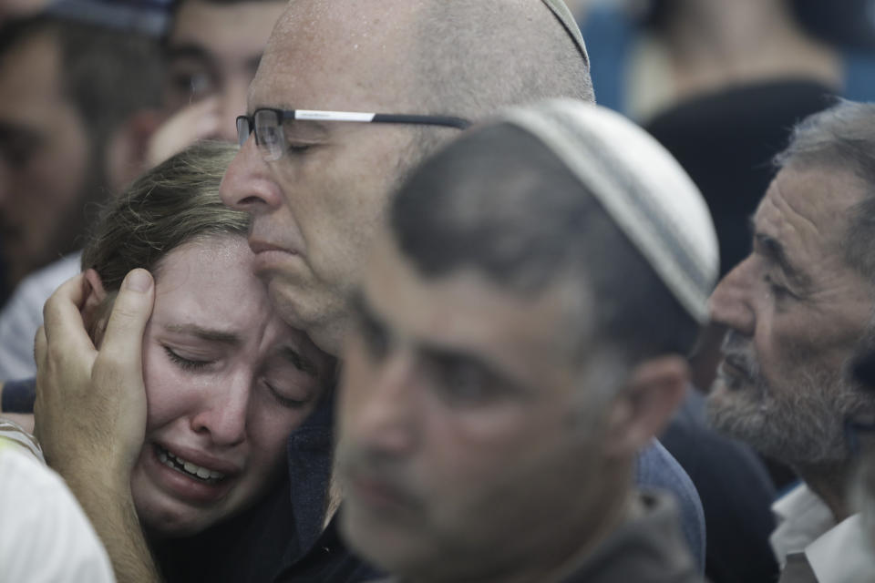People attend the fineral of 17 year opld Rina Shnerb, in Lod, Israel, Friday, Aug. 23, 2019. Shnerb has died of wounds from an explosion in the West Bank that the Israeli military has described as a Palestinian attack. (AP Photo/Sebastian Scheiner)