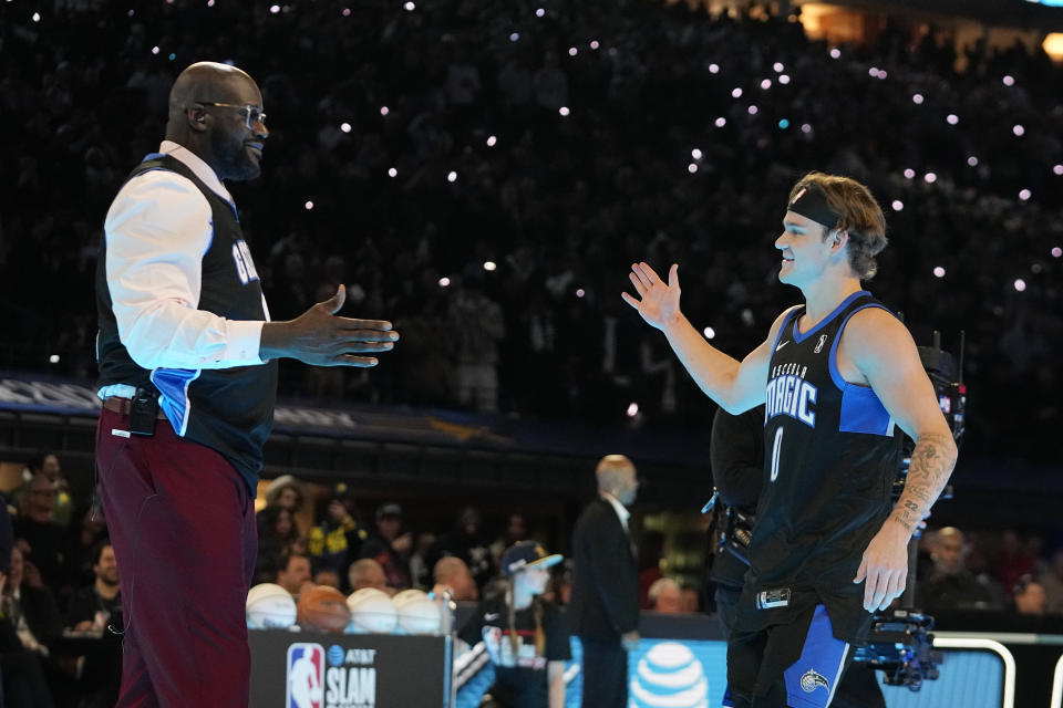 Osceola Magic's Mac McClung is greeted by Shaquille O'Neal during the slam dunk competition at the NBA basketball All-Star weekend, Saturday, Feb. 17, 2024, in Indianapolis. (AP Photo/Darron Cummings)