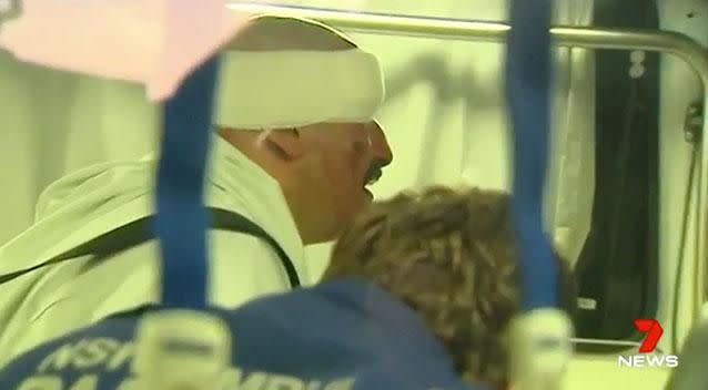 One of the arrested men pictured with a bandaged head. Photo: 7 News