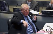 Toronto Mayor Rob Ford sips a cup of coffee during a city council meeting in Toronto November 15, 2013. Toronto city council voted to strip the scandal-plagued mayor of some of his powers on Friday but Ford, who admits he smoked crack cocaine while in office, promised to challenge the moves in court. REUTERS/Jon Blacker (CANADA - Tags: POLITICS)