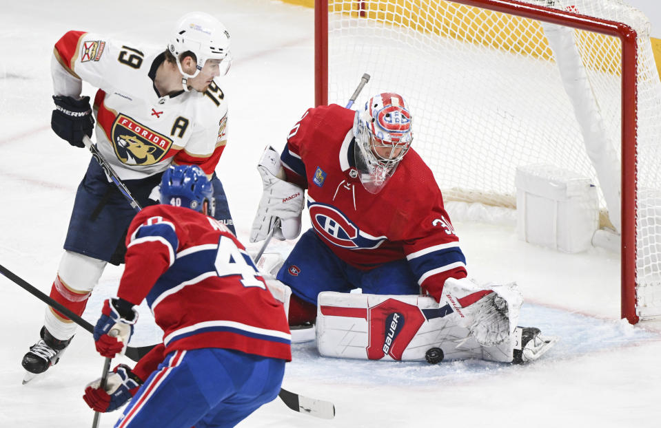 Montreal Canadiens goaltender Cayden Primeau stops Florida Panthers' Matthew Tkachuk (19) as Candiens' Joel Armia defends during the third period of an NHL hockey game in Montreal, Thursday, Nov. 30, 2023. (Graham Hughes/The Canadian Press via AP)