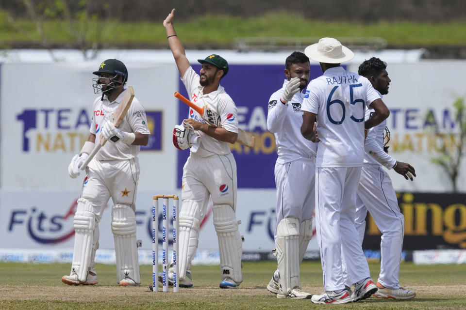 Pakistan's Agha Salman, second left, waves towards the pavilion after scoring the wining runs as Imam-ul-Haq walk with him after Pakistan defeated Sri Lanka by four wickets in the first cricket test match between Sri Lanka and Pakistan in Galle, Sri Lanka on Thursday, July 20, 2023. (AP Photo/Eranga Jayawardena)