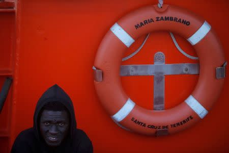 A migrant, intercepted aboard a toy dinghy off the coast in the Strait of Gibraltar, waits on a rescue boat to disembark after arriving at the port of Algeciras, southern Spain. REUTERS/Jon Nazca