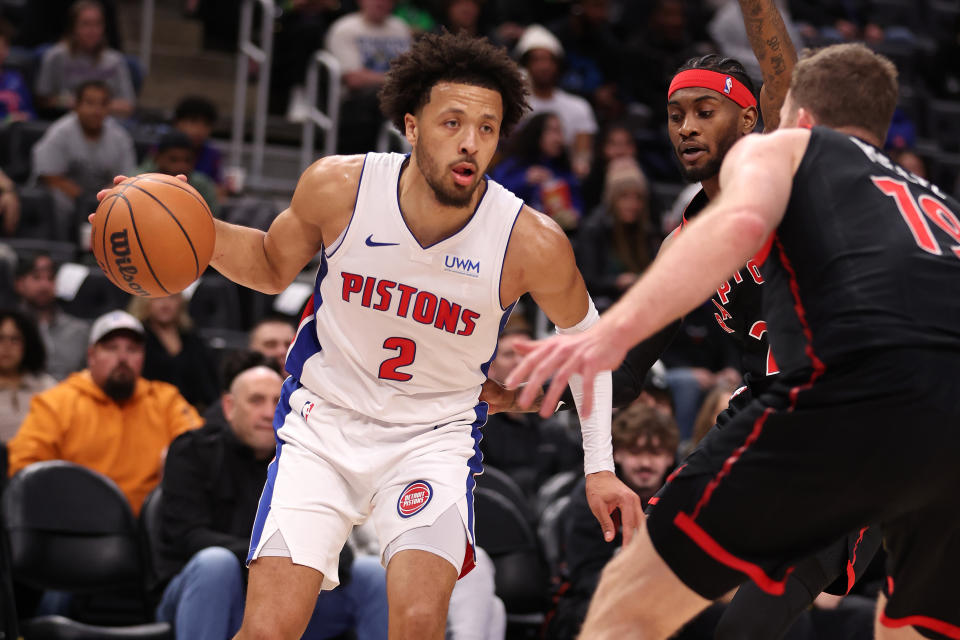 DETROIT, MICHIGAN - DECEMBER 30: Cade Cunningham #2 of the Detroit Pistons looks to drive around Jakob Poeltl #19 of the Toronto Raptors during the first half at Little Caesars Arena on December 30, 2023 in Detroit, Michigan. NOTE TO USER: User expressly acknowledges and agrees that, by downloading and or using this photograph, User is consenting to the terms and conditions of the Getty Images License Agreement. (Photo by Gregory Shamus/Getty Images)
