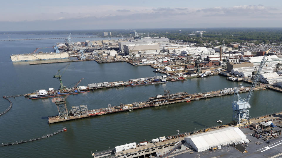 FILE - The Newport News Shipbuilding is seen in Newport News, Va., April 27, 2016. A Navy investigation prompted by a spate of suicides is recommending widespread improvements in housing, food, parking and internet for sailors as well as changes to mental health and other personnel programs. The inquiry concluded that several suicides at the Newport News shipyard last year were not connected or caused by any one issue. But the deaths brought to light pervasive problems and poor living conditions, particularly among young enlisted sailors doing long-term ship maintenance at that base and others around the United States. (AP Photo/Steve Helber, File)