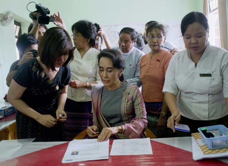 Myanmar's opposition leader Aung San Suu Kyi submits her electoral registration form at a district court in Yangon, on July 29, 2015