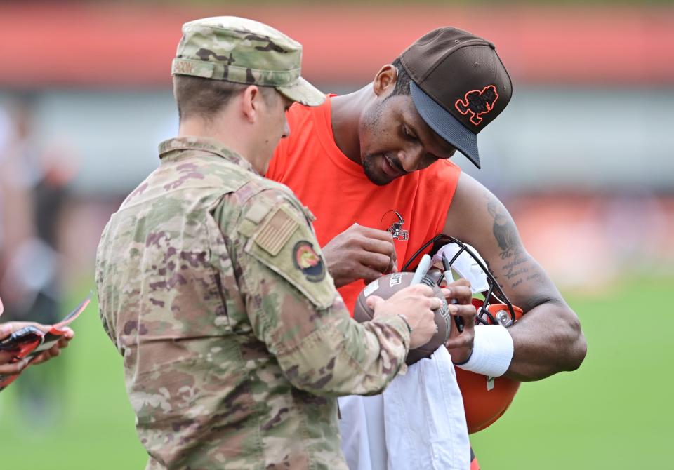 Browns quarterback Deshaun Watson signs an autograph for a member of the military during organized team activities in Berea, May 25, 2022.