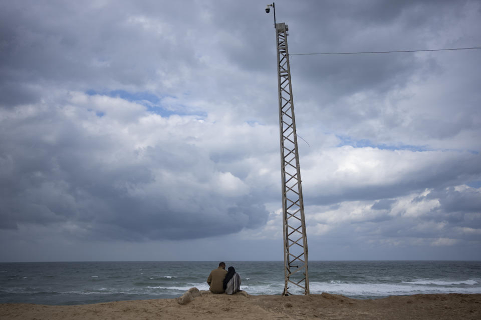 Palestinians displaced by the Israeli air and ground offensive on the Gaza Strip sit on the beach in Rafah on the border with Egypt, Saturday, Jan. 27, 2024. (AP Photo/Fatima Shbair)