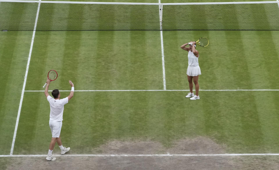 Britain's Neal Skupski, left, and Desirae Krawczyk of the U.S. celebrate after defeating Britain's Joe Salisbury and Harriet Dart during the mixed doubles final match on day thirteen of the Wimbledon Tennis Championships in London, Sunday, July 11, 2021. (AP Photo/Alberto Pezzali)