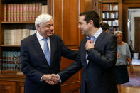 Greek Prime Minister Alexis Tsipras (R) shakes hands with Greek President Prokopis Pavlopoulos during a meeting at the presidential palace in Athens, Greece, June 22, 2018. Panayiotis Tzamaros/Intimenews via REUTERS