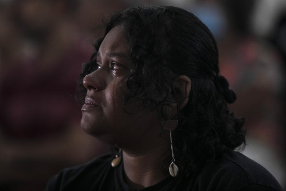 A woman cries during a Mass in honor of slain councilwoman Marielle Franco and her driver Anderson Gomes, to mark five years since their murders still under investigation, in Rio de Janeiro, Brazil, Tuesday, March 14, 2023. (AP Photo/Bruna Prado)