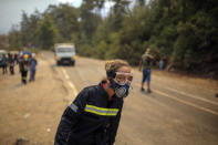 A Turkish volunteer runs as they head to fight wildfires in Turgut village, near tourist resort of Marmaris, Mugla, Turkey, Wednesday, Aug. 4, 2021. As Turkish fire crews pressed ahead Tuesday with their weeklong battle against blazes tearing through forests and villages on the country's southern coast, President Recep Tayyip Erdogan's government faced increased criticism over its apparent poor response and inadequate preparedness for large-scale wildfires.(AP Photo/Emre Tazegul)