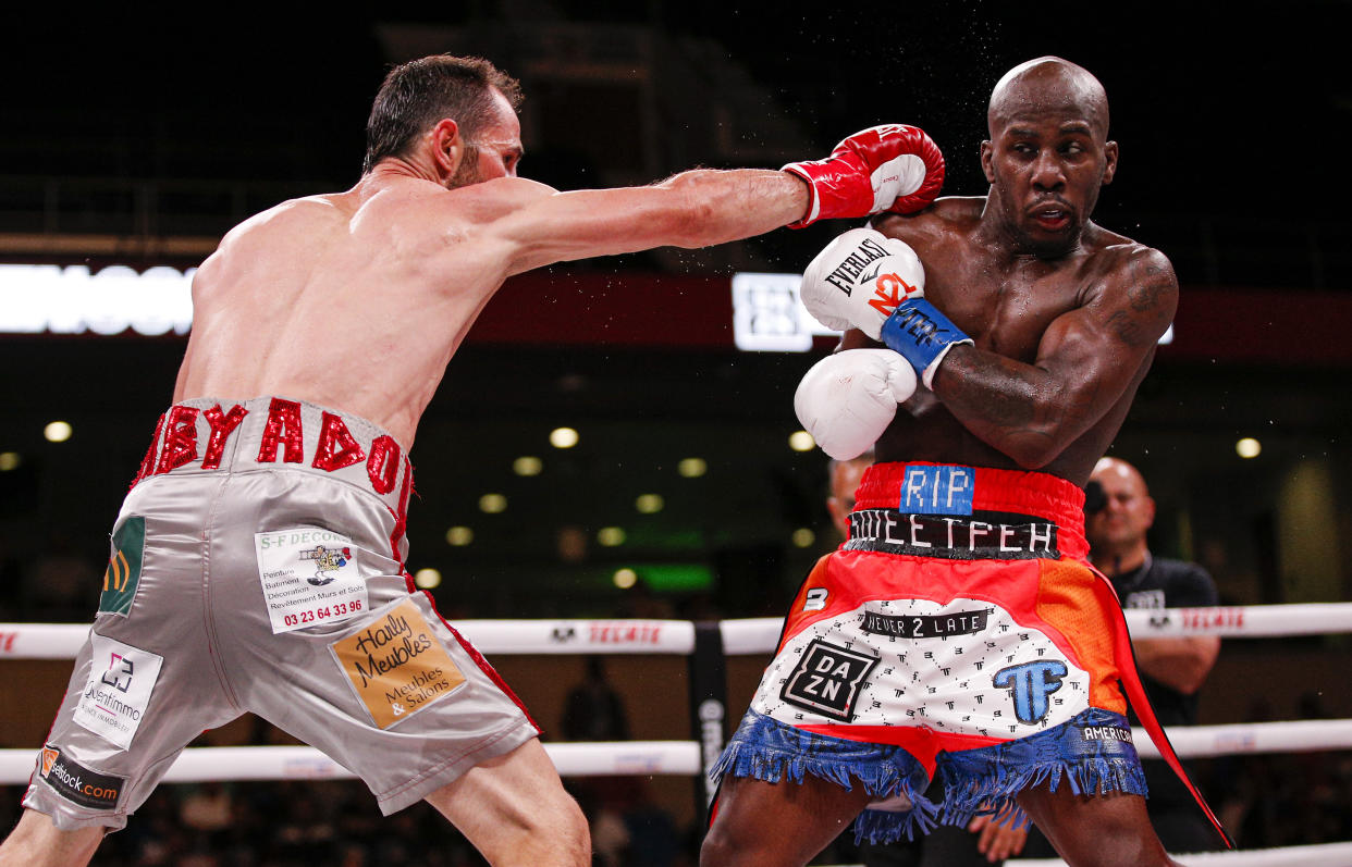 Tevin Farmer, right, dodges a punch from Guillaume Frenois during the fourth round of a boxing match, Saturday, July 27, 2019, in Arlington, Texas. Farmer won the 12 round match. (AP Photo/Brandon Wade)