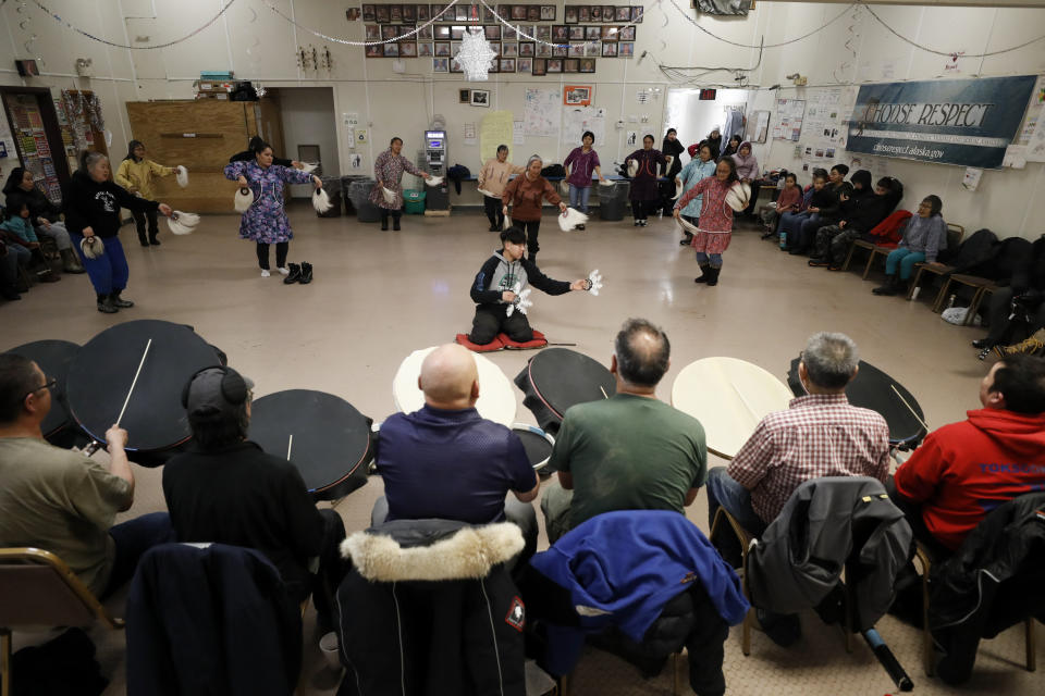 In this Monday, Jan. 20, 2020 photo, people take part in an Alaska Native dance in Toksook Bay, Alaska, a mostly Yup'ik village on the edge of the Bering Sea. Census workers traditionally begin the official decennial count in rural Alaska when the ground is still frozen. That allows easier access before the spring melt makes many areas inaccessible to travel and residents scatter to subsistence hunting and fishing grounds. The rest of the nation, including more urban areas of Alaska, begin the census in mid-March. (AP Photo/Gregory Bull)