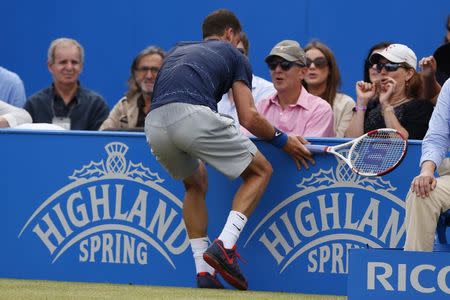 Bulgaria's Grigor Dimitrov stops in front of spectators after trying to return the ball to Switzerland's Stanislas Wawrinka during their men's singles semi-final tennis match at the Queen's Club Championships in west London June 14, 2014. REUTERS/Stefan Wermuth