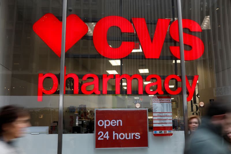 FILE PHOTO: People walk by a CVS Pharmacy store in the Manhattan borough of New York City