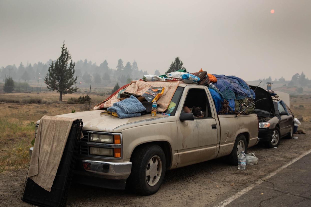 Regina Rutledge sits in her truck packed with personal belongings near an evacuation center on Aug. 7, 2021, in Summerville, Calif. The Dixie Fire is reported to have burned 447,723 acres and to be only 21% contained.