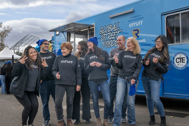 <p>Intuit</p> Intuit employees in Dec. 2023 in front of a brand-new food truck donated to a high school. The program gives practical, work-based learning experiences to underserved students.