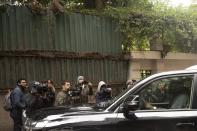 Journalists film a vehicle leaving the house of ex-Nissan chief Carlos Ghosn in Beirut, Lebanon, Friday, Jan. 3, 2020. The former Nissan Motor Co. Chairman fled Japan this week while awaiting trial on financial misconduct charges and appeared in Lebanon. (AP Photo/Maya Alleruzzo)