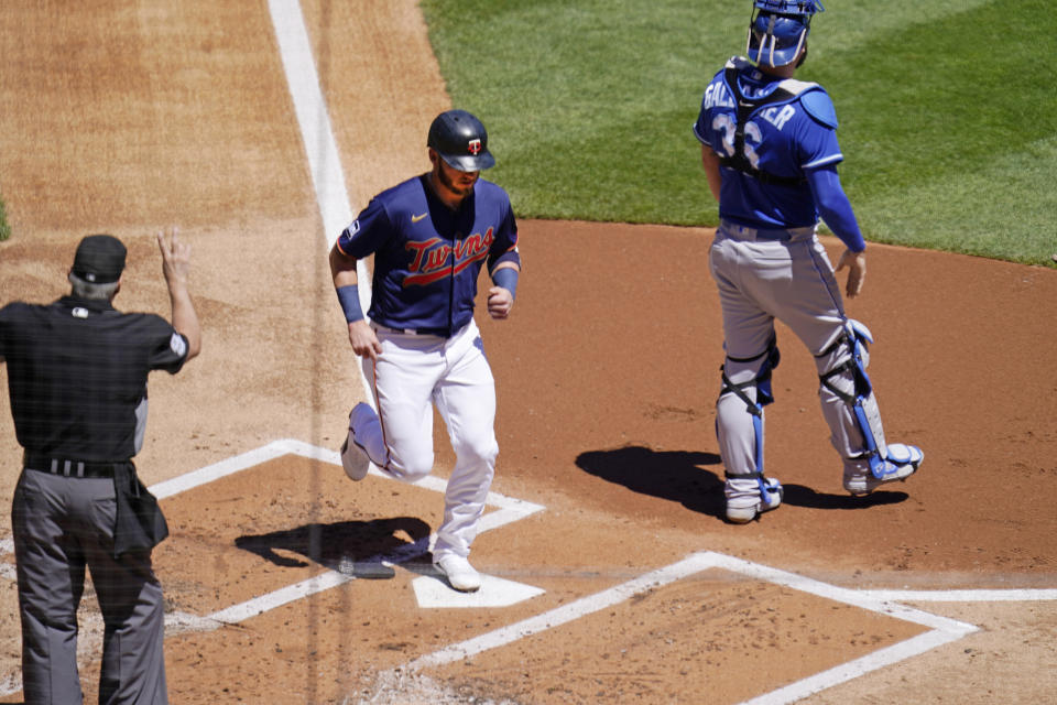 Minnesota Twins' Josh Donaldson scores on a ground-rule double by Nelson Cruz in the first inning of a baseball game against the Kansas City Royals, Saturday, May 29, 2021, in Minneapolis. It was the 2 millionth run scored in Major League Baseball history, according to Elias Sports Bureau. (AP Photo/Jim Mone)