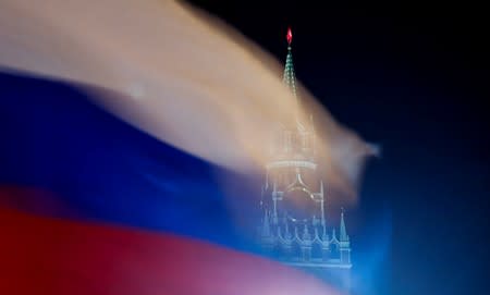 FILE PHOTO: Russian flag flies with the Spasskaya tower of Moscow's Kremlin in the background in Moscow