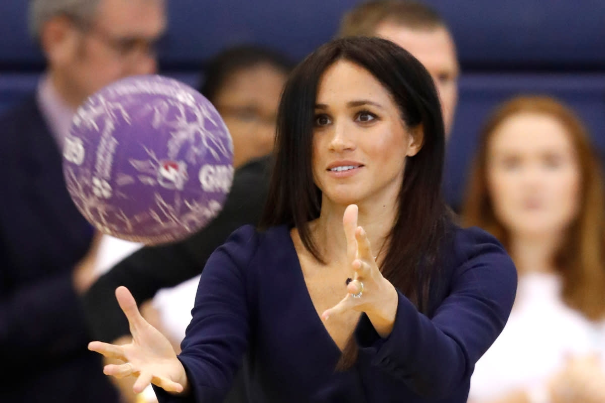 The Duchess of Sussex takes part in a netball workshop (Getty)