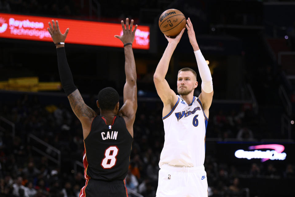 Washington Wizards center Kristaps Porzingis (6) shoots against Miami Heat forward Jamal Cain (8) during the first half of an NBA basketball game Friday, Nov. 18, 2022, in Washington. (AP Photo/Nick Wass)