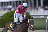 Flavien Prat atop Rombauer, center, reacts after winning the Preakness Stakes horse race at Pimlico Race Course, Saturday, May 15, 2021, in Baltimore. (AP Photo/Nick Wass)