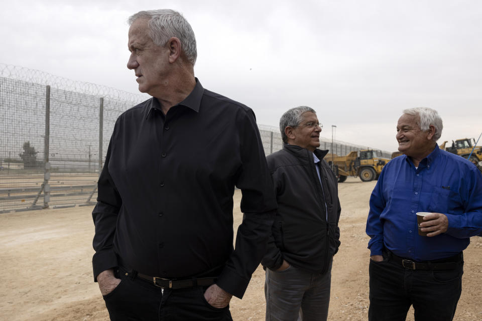 Israeli Defense Minister Benny Gantz, left, attends a ceremony marking the completion of the enhanced security barrirer along the Israel- Gaza border, Tuesday, Dec. 7, 2021. Israel has announced the completion of the enhanced security barrier around the Gaza Strip designed to prevent militants from sneaking into the country. (AP Photo/Tsafrir Abayov)