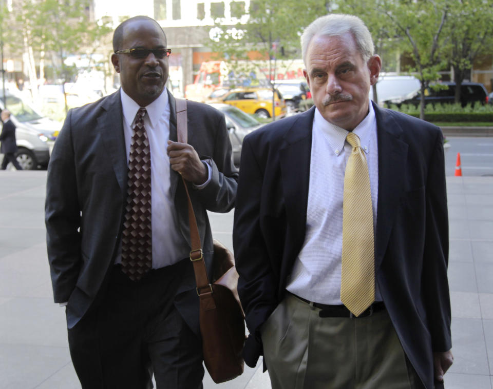 New Orleans Saints assistant coach Joe Vitt, right, arrives with attorney David Cornwell for a meeting at NFL headquarters in New York, Thursday, April 5, 2012. (AP Photo/Seth Wenig)