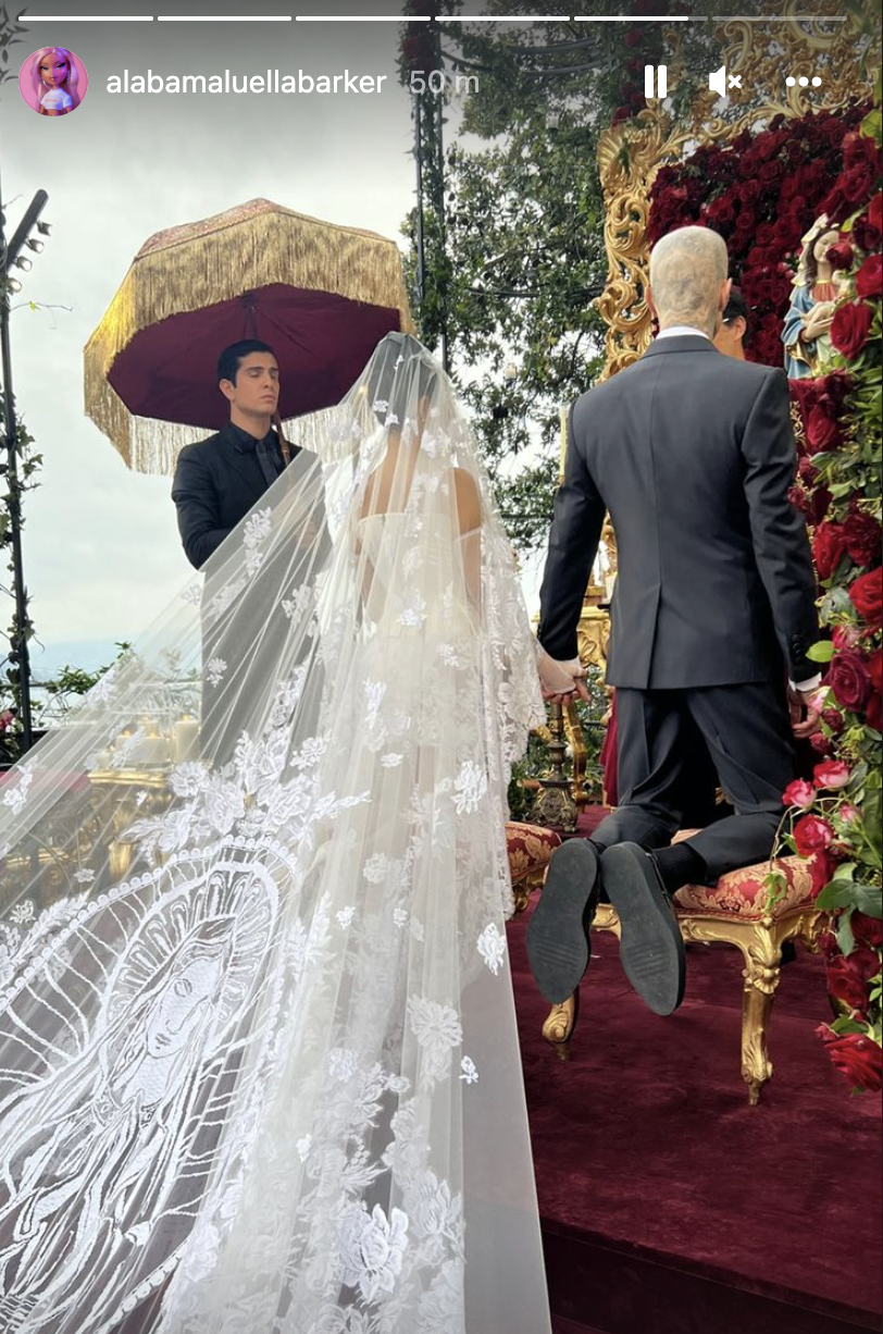 Kardashian wore a white wedding dress with a lengthy train featuring the Virgin Mary during the nuptials. (Photo: Alabama Barker/Instagram Stories)