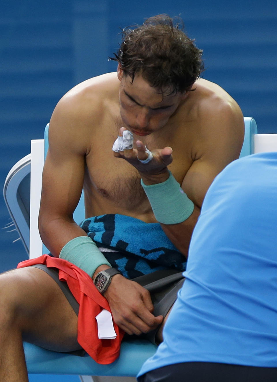 Rafael Nadal of Spain looks at a blister on his hand during his fourth round match against Kei Nishikori of Japan at the Australian Open tennis championship in Melbourne, Australia, Monday, Jan. 20, 2014. (AP Photo/Aaron Favila)