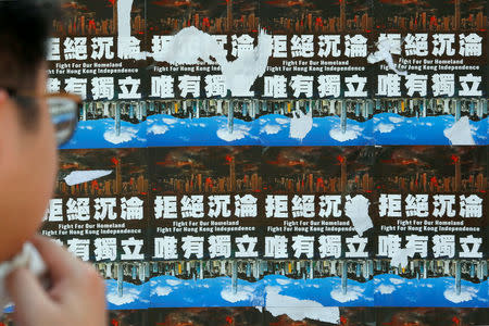 A student looks at posters on Hong Kong independence displayed at the Chinese University of Hong Kong in Hong Kong, China September 8, 2017. Picture taken September 8, 2017. REUTERS/Bobby Yip